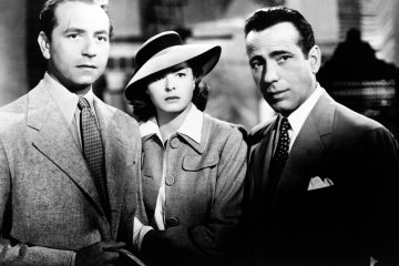 Medium shot of Paul Henreid as Victor Laszlo, Ingrid Bergman as Ilsa Lund, wearing hat, and Humphrey Bogart as Rick Blaine.