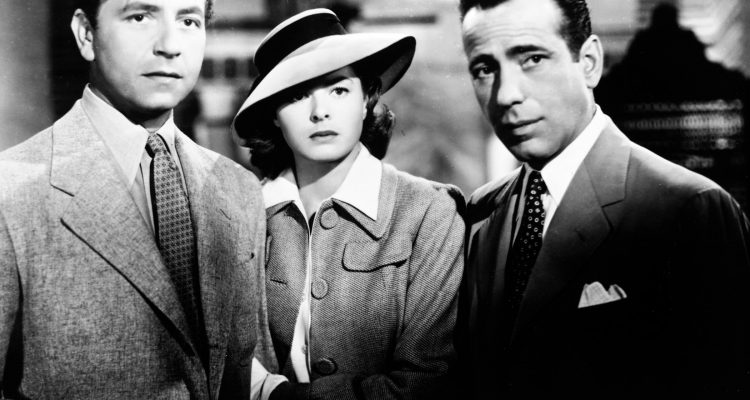 Medium shot of Paul Henreid as Victor Laszlo, Ingrid Bergman as Ilsa Lund, wearing hat, and Humphrey Bogart as Rick Blaine.