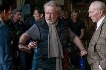 Mark-Wahlberg,-left,-and-Christopher-Plummer,-right,-listen-to-director-Ridley-Scott-during-reshoots-of-'All-The-Money-In-The-World.'