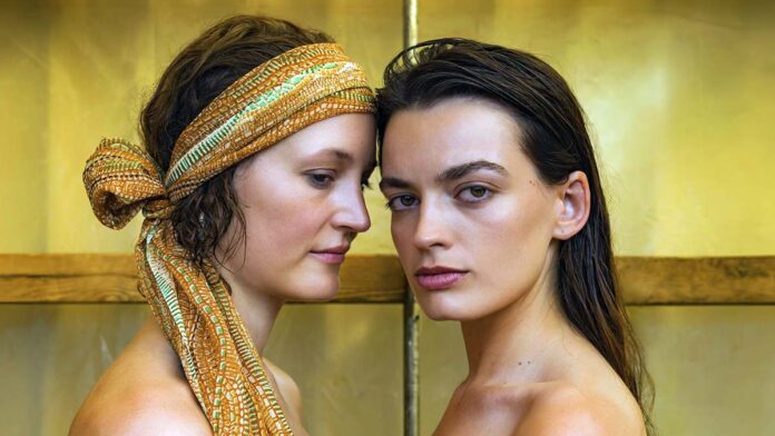 Emma Mackey and Vick y Krieps in Rebecca Lenkiewicz ’ s HOT MILK. Courtesy of Nikos Nikolopoulos . An IFC Films Release