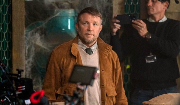 Guy Ritchie Talks ‘Fountain Of Youth,’ The “Not Transparent” Movie Business, And Why He Hasn’t Given Up On ‘Sherlock 3’
